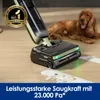 A wet dry vacuum cleaner is shown cleaning up a spill on a wooden floor, with a dog lying in the background. Produktbild-Vorschau