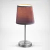 A table lamp with a fabric shade is shown against a light gray background. Náhled obrázku produktu