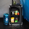 Inside a tent, a camping cabinet is set up with various camping supplies. Podgląd zdjęcia produktu