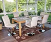 A dining set with chairs and a table in a sunroom with a garden view. Náhled obrázku produktu