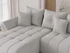 A close-up view of a light gray sectional sofa with multiple throw pillows. Produktbild-Vorschau