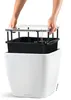 Hands assembling a white planter with a black insert. Náhled obrázku produktu