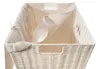 A close-up view of the top of a white wicker laundry basket with a beige fabric liner. Náhľad obrázku produktu