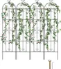 Four black metal trellises covered in artificial green vines and pink flowers, standing upright against a white background. A small wrench and Allen key are visible in the bottom right corner. Produktbild-Vorschau