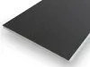 A close-up, angled view of a single tile of click-vinyl flooring with a textured black surface and a white edge. Produktbild-Vorschau