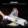 A person is using a potato grater to slice a potato. Náhled obrázku produktu