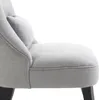 A close-up view of a gray upholstered chair with a small pillow. Voir les images du produit
