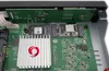Close-up view of internal electronic components of a device, including circuit boards, a heatsink with a logo, and an SSD. Náhled obrázku produktu