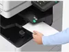 A person's hands are inserting a piece of paper into a printer. Produktbild-Vorschau