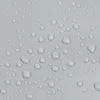 A close-up view of water droplets on a textured gray surface. Náhled obrázku produktu