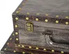 A close-up view of a vintage-style storage box with brass-colored hardware and rivets. Produktbild-Vorschau
