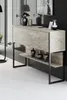 A modern console table with a travertine-like finish and black metal legs, decorated with vases and a framed picture. Podgląd zdjęcia produktu