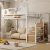 A white metal loft bed with stairs and storage is set up in a child's room, featuring a sofa underneath and toys on the floor. Produktbild-Vorschau