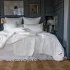 A bedroom scene with a neatly made bed featuring white bedding. Produktbild-Vorschau