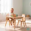 A baby is playing with wooden blocks at a child's table and chairs set. Produktbild-Vorschau