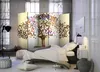 A bedroom scene with a bed, a room divider, and decorative elements. Anteprima dell’immagine prodotto