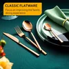 A close-up shot of rose gold cutlery set on a teal surface, with plates and a napkin in the background. Produktbild-Vorschau