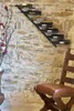 A wine rack mounted on a stone wall, with a chair in the foreground. Podgląd zdjęcia produktu