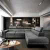A modern living room with a large sectional sofa and a dark stone accent wall. Produktbild-Vorschau