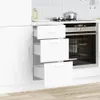 A white kitchen cabinet with drawers open, revealing the interior, next to a built-in oven. Voir les images du produit