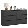 A modern black dresser with six drawers, decorated with a lamp, a framed photo, a potted plant, a candle, and books. Náhľad obrázku produktu