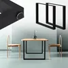 A table and chairs set, with a close-up of a black table leg and two black table leg frames. Podgląd zdjęcia produktu