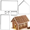 A set of gingerbread house cookie cutters and a finished gingerbread house. Voir les images du produit