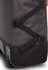 A close-up view of the bottom corner of a rolling suitcase, showing the wheels and straps. Podgląd zdjęcia produktu