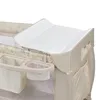 A close-up view of a baby changing station attached to a playpen. Produktbild-Vorschau