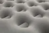 A close-up, abstract view of an inflated mattress or airbed, showing its quilted texture and dimpled surface. Podgląd zdjęcia produktu