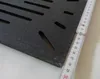 A close-up of a black grate with a ruler placed on it. Náhľad obrázku produktu