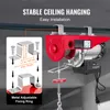 A red electric hoist is shown hanging from a ceiling beam, with an inset diagram illustrating its mounting hardware. Podgląd zdjęcia produktu