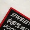 A close-up view of a doormat with text and symbols on it, placed on a light-colored wooden floor. Produktbild-Vorschau