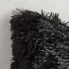 A close-up view of the texture of a black fluffy pillowcase. Produktbild-Vorschau