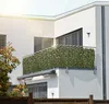 A balcony with a green leaf privacy screen attached to the railing. Anteprima dell’immagine prodotto
