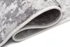 A close-up view of a rolled-up rug, showing the texture and edge binding. Produktbild-Vorschau