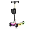 A three-wheeled scooter for children with LED lights on the wheels and deck, and a basket attached to the handlebars. Anteprima dell’immagine prodotto