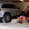 A diesel heater is shown next to a silver SUV in a garage with snow on the ground. Voir les images du produit