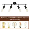 A black ceiling light fixture with four adjustable spotlights, each holding an Edison-style bulb. Below the fixture, there is a brown banner with German text, followed by an image showcasing five different types of E27 light bulbs. Voir les images du produit