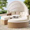 An outdoor lounge set with a canopy, cushions, and a table, situated on a patio next to a pool. Voir les images du produit