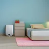 A bedroom scene with a bed, nightstand, and an air purifier. Produktbild-Vorschau