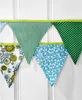 A string of fabric bunting flags with different patterns. Produktbild-Vorschau