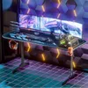 A gaming desk setup with multiple monitors, a keyboard, mouse, headphones, and a computer tower. Podgląd zdjęcia produktu