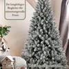 A flocked artificial Christmas tree is shown in a festive indoor setting, with decorative elements like a gingerbread house and a plush toy visible. Produktbild-Vorschau