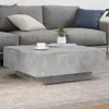 A modern living room setting with a grey sectional sofa and a concrete-look coffee table. Voir les images du produit