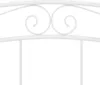 A close-up of a white metal bed frame headboard with decorative scrollwork. Podgląd zdjęcia produktu