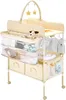 A baby changing station with storage and hanging clothes. Anteprima dell’immagine prodotto