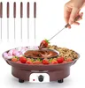 A hand is dipping a strawberry into a chocolate fondue pot. Produktbild-Vorschau