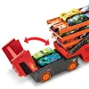 A toy truck with multiple toy cars loaded onto it, with some cars being released from the truck. Náhled obrázku produktu
