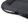 A close-up view of a dog bed with a zipper partially open, revealing the filling. Produktbild-Vorschau